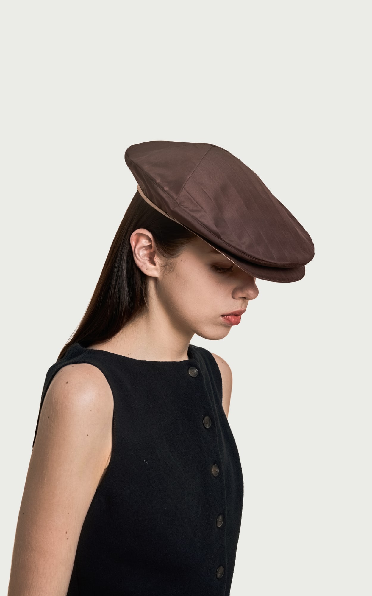 Satin Brown Pleated Foldable Hat worn by a model